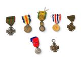 several medals are arranged in a row on a white surface