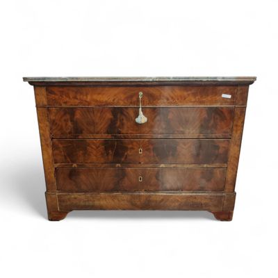 an antique chest of drawers with marble top
