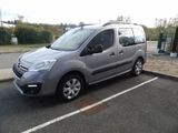 a small silver van parked in a parking lot