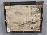 a close up of a piece of paper with a newspaper on top of it
