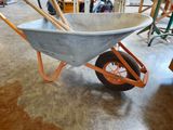 a wheelbarrow in the middle of a room with tools in it
