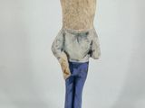 a figurine of a teddy bear dressed in blue pants and a white shirt