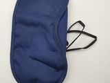 a close up of a blue eye mask laying on top of a white table
