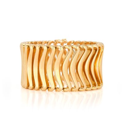 an image of a gold ring with wavy waves on it
