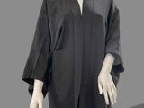an image of a mannequin wearing a black coat and black pants