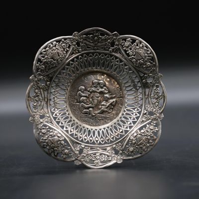silver plate with a picture of a man and a woman on it