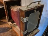 two old cameras on display on a wooden table