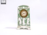 une horloge verte et blanche posée sur une table