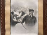 framed photograph of a man standing next to a cow wearing a hat