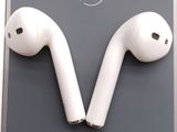 a pair of airpods sitting on top of a cell phone