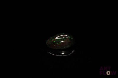 an image of a black and green stone in the dark