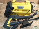 a yellow and black power washer and other tools on a table