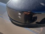 a reflection of a person in the side mirror of a car