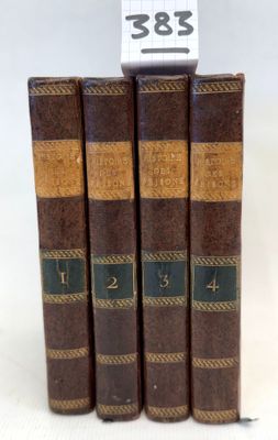 three books are stacked on top of each other on a white surface