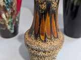 three vases that are sitting on a table