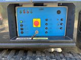 the back end of a truck with a blue panel and red button