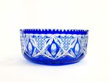 an image of a blue glass bowl sitting on top of a white table