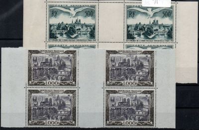 four stamps with a picture of a city on them on a table