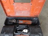 an orange tool box with tools in it sitting on a concrete floor