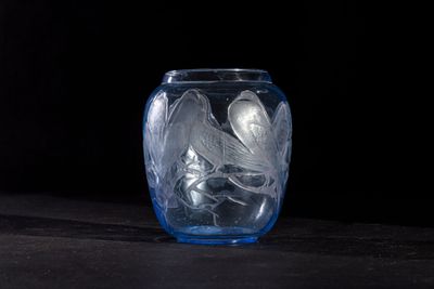 a glass vase with a lot of ice in it on a table