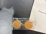 a piece of paper with a piece of gold coins on it