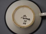 a coffee cup with writing on it sitting on a saucer