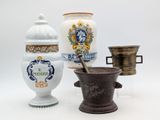 three different types of vases and a mortar on a white surface