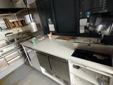 a kitchen with a stove, sink, and oven in it