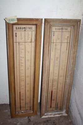 two wooden doors that have a barometer on them