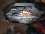 a black bag with tools inside of it on the floor