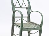 a green chair that is sitting on a white surface
