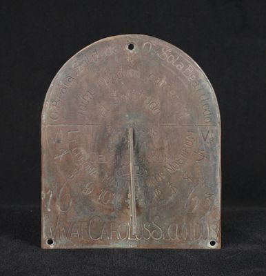an old bronze plate with a clock on it