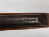 a close up of a shotgun with a wooden handle