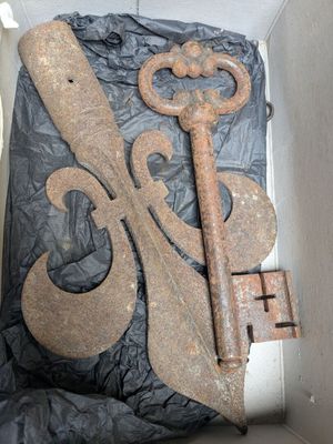 an old rusty key in a box on the floor