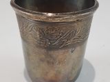 a silver cup that is sitting on a table
