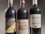 three bottles of red wine sit next to each other on a table