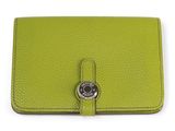 a green leather wallet with a metal button on the front