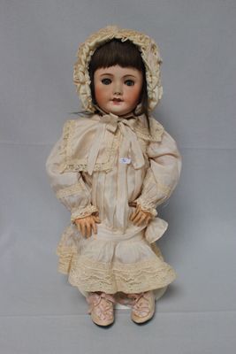 a doll that is sitting on a white surface