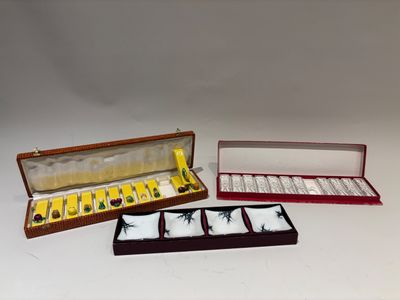 three boxes with different items in them sitting on a white surface