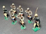 seven figurines of men in uniforms on a table