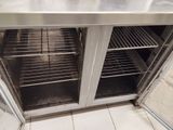 a stainless steel counter top with two ovens inside of it