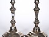 pair of antique silver candlesticks on stands with numbers on them