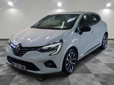 the white car is parked on a checkered floor in a garage