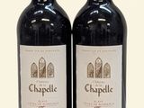 two bottles of wine sitting next to each other on a table