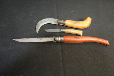 three different types of knives on a black surface