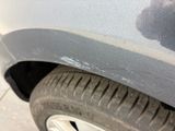 a close up of a car ' s front bumper with scratches on it
