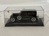 a black model of a car in a clear case