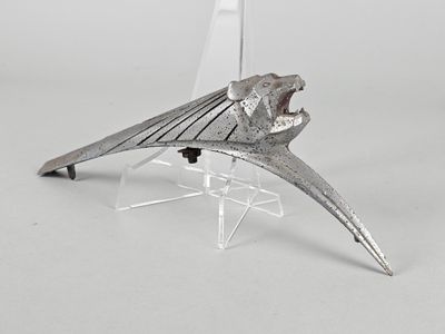 a metal object that is sitting on a clear stand