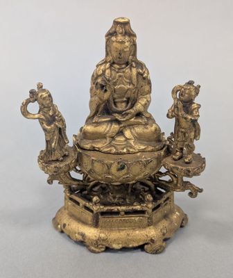 an image of a statue of a person sitting on top of a table