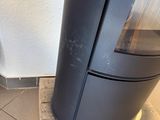 a black stove in the corner of a room